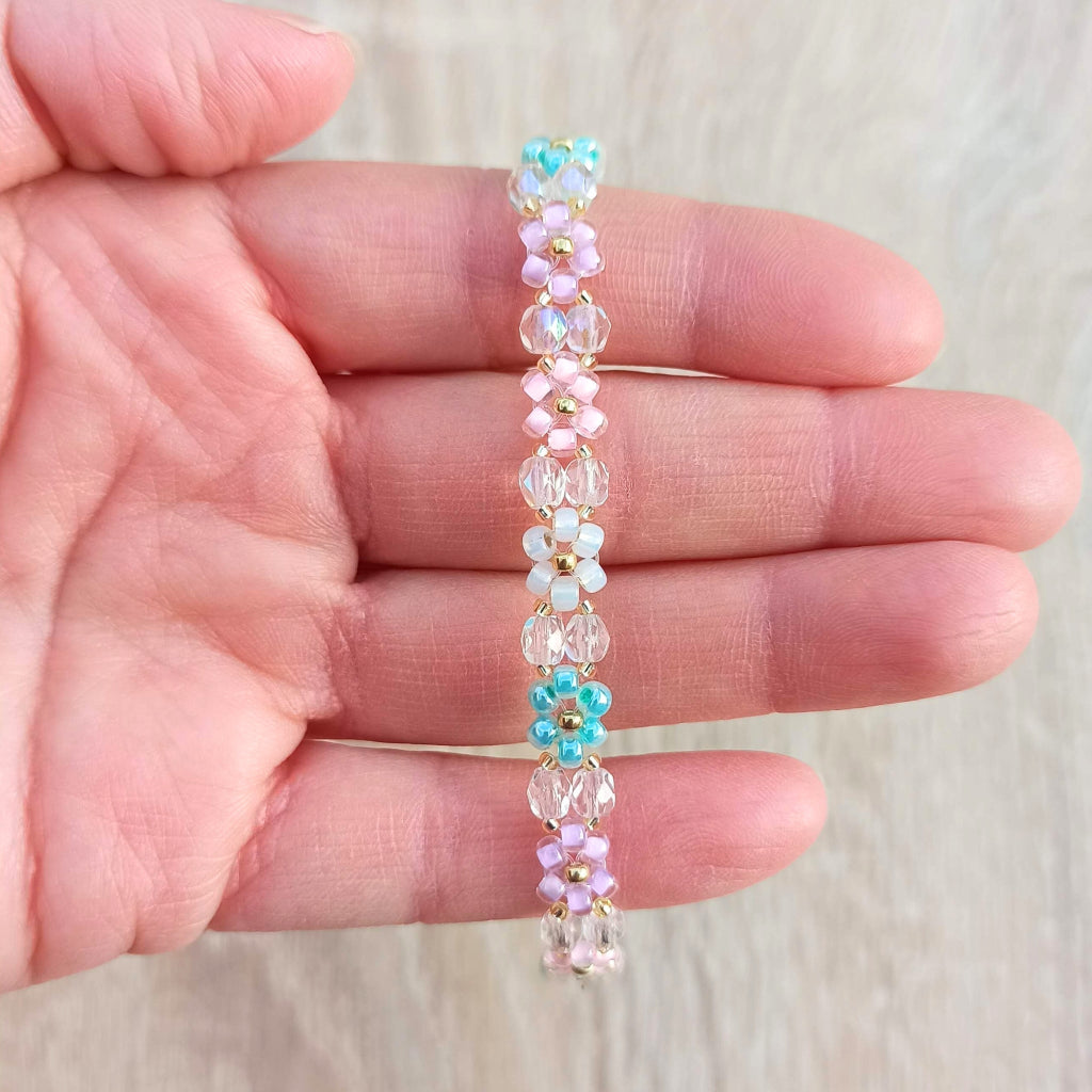 Geregen armbandje met miyukikraaltjes, rocailles, kleine kraaltjes in pasteltinten en goud. 