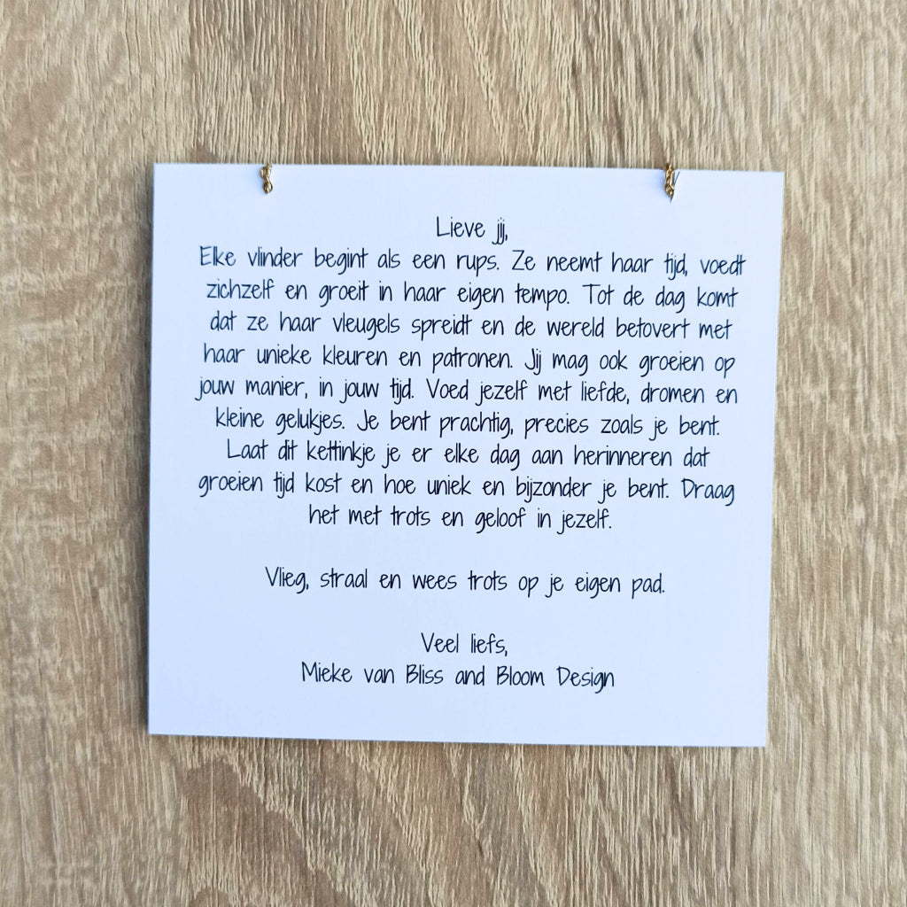 Kaartje bij een kettinkje met tekst over de evolutie van een rups tot vlinder. Het is een daily reminder dat je mag groeien op je eigen tempo en dat je uniek en bijzonder bent. 